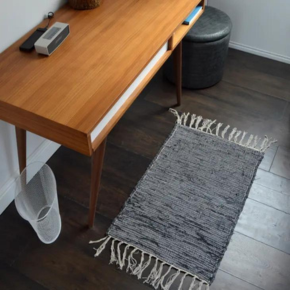Home office desk with grey tasselled rug under
